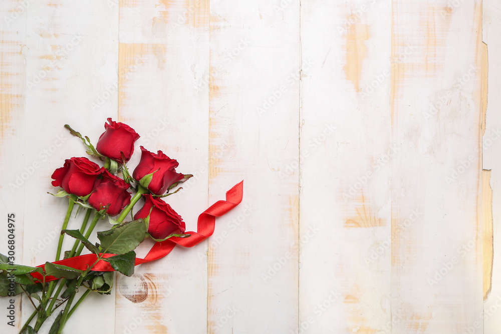 Beautiful bouquet of roses on white wooden background