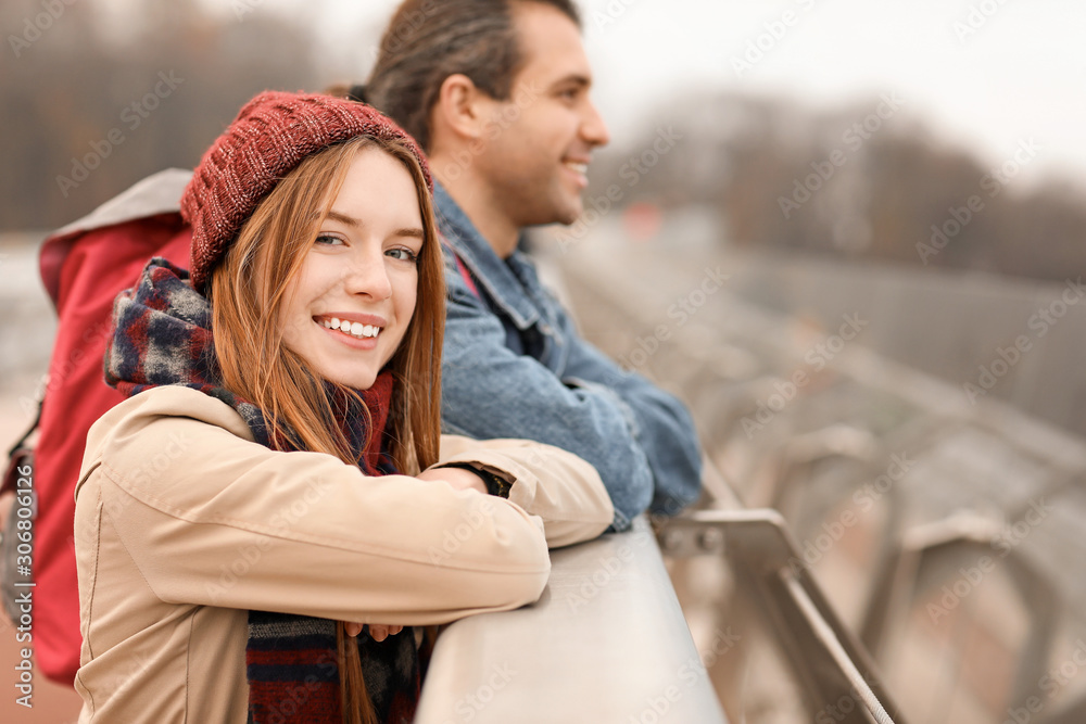 Happy couple on bridge in autumn city