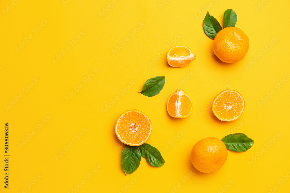 Ripe tasty tangerines on color background