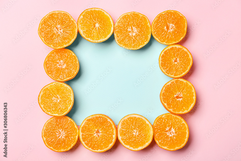 Frame made of ripe tasty tangerines on color background