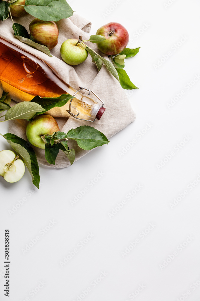 Apple cider vinegar and fresh apples, flat lay, space for your text