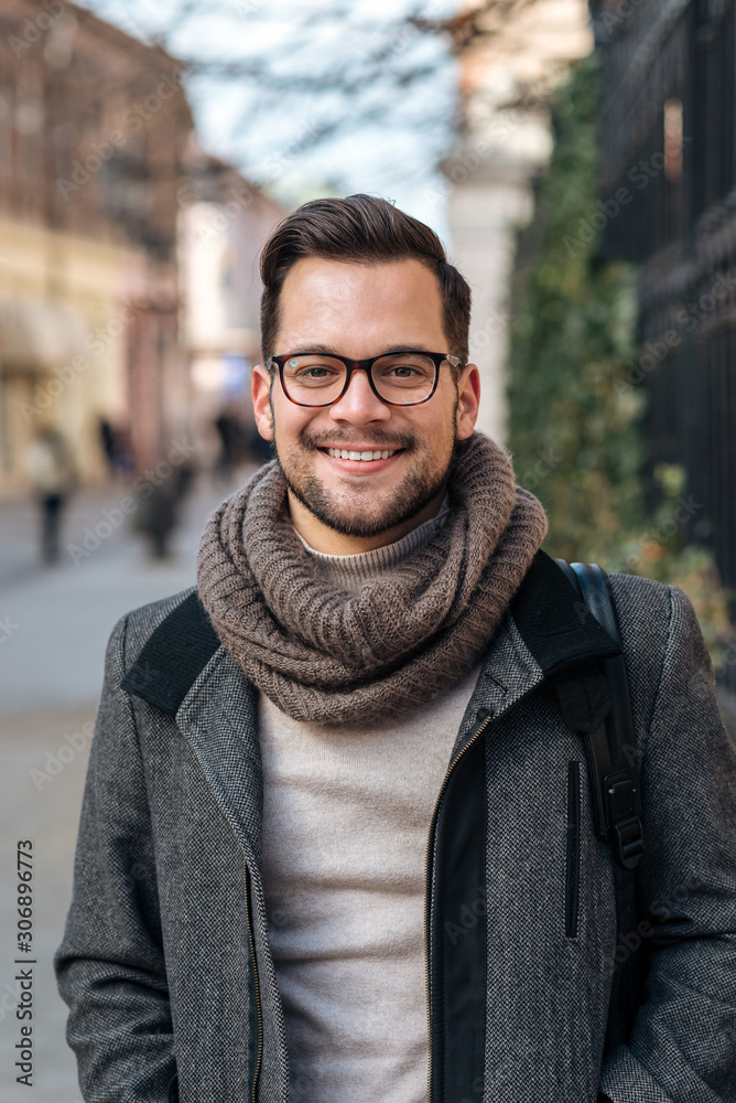 Winter portrait of young entrepreneur in the city.