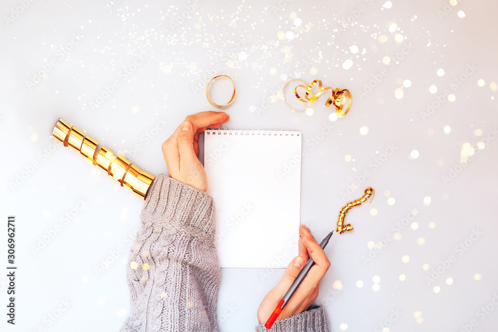 White notebook with hands.