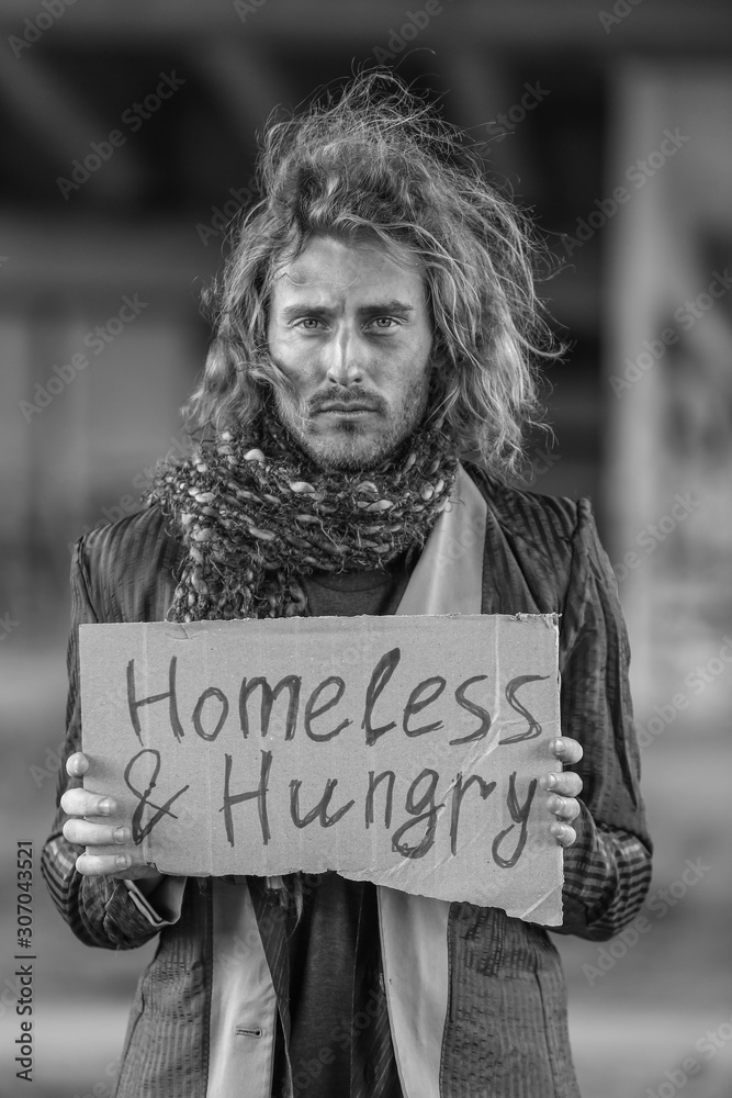 Black and white portrait of poor homeless man outdoors