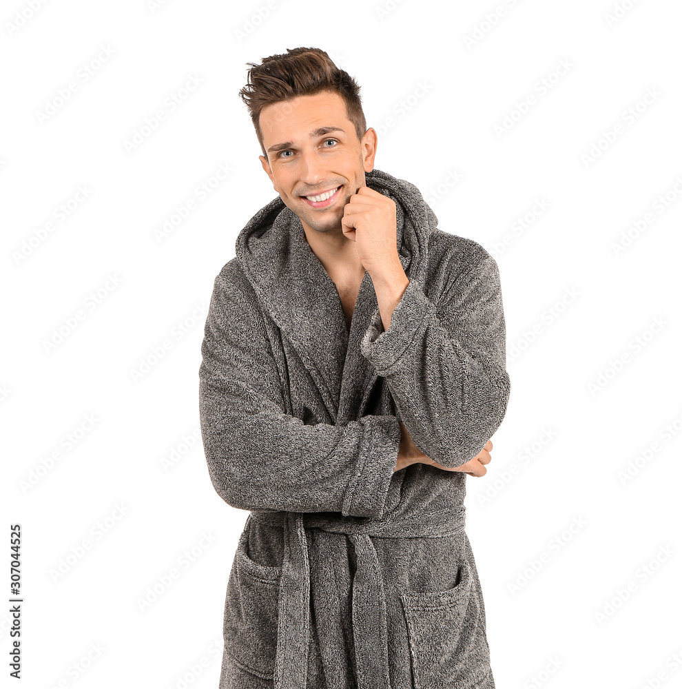 Handsome man in bathrobe on white background