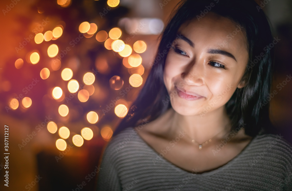 Beautiful asian girl in christmas decorated home at evening