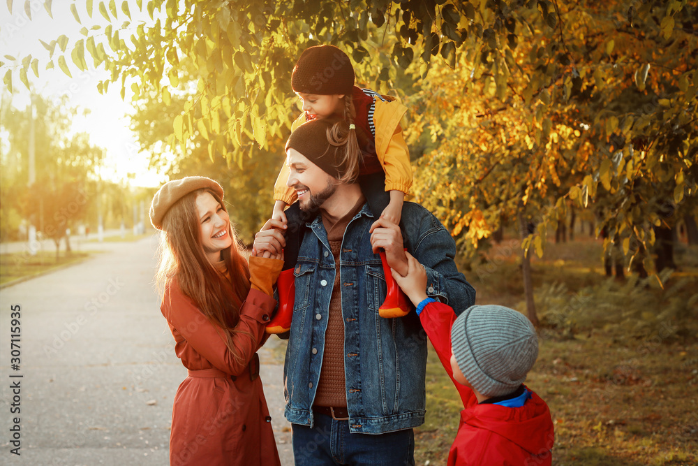 Happy family in autumn park