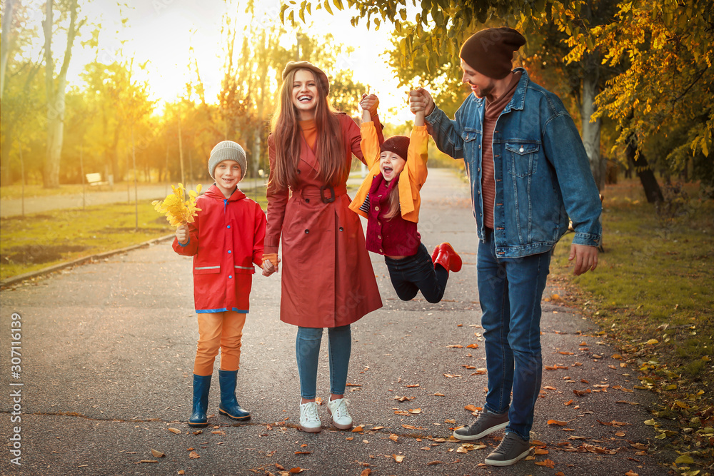 Happy family having fun in autumn park