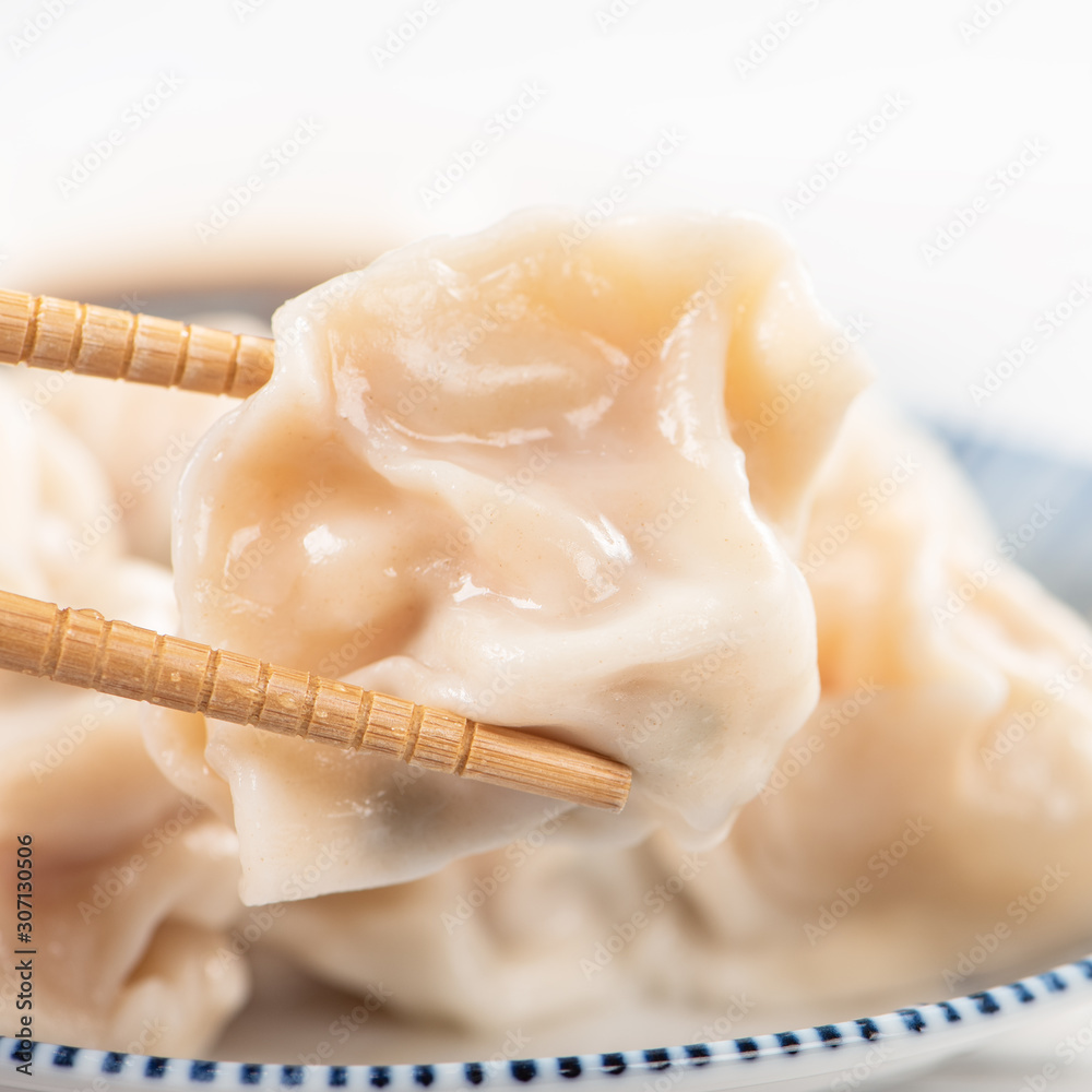 Fresh, delicious boiled pork, shrimp gyoza dumplings on white background with soy sauce and chopstic