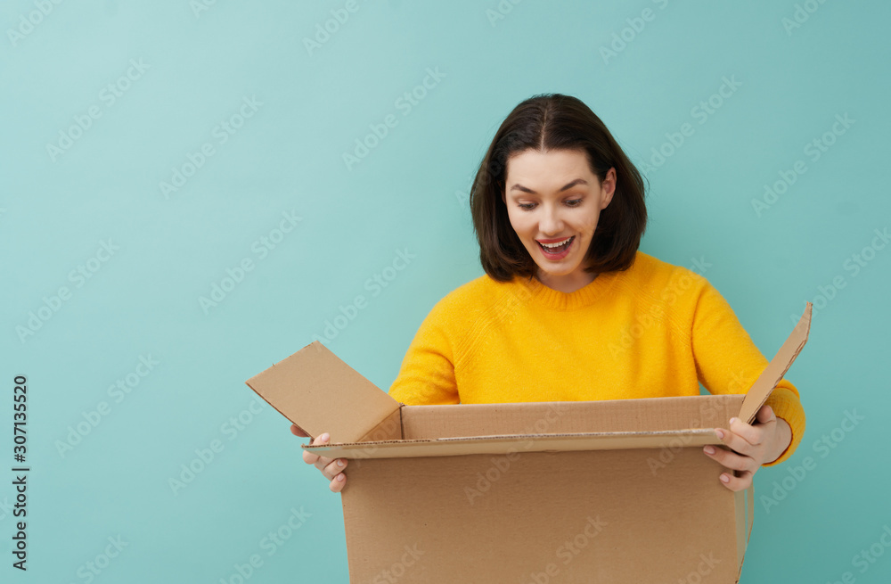 woman is holding cardboard box