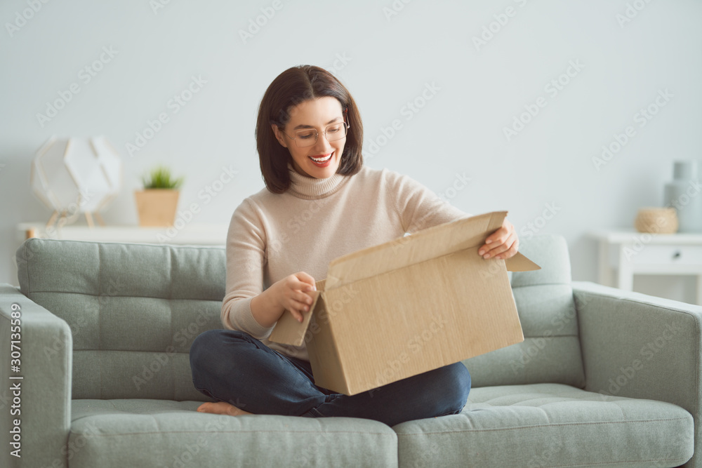 woman is holding cardboard box