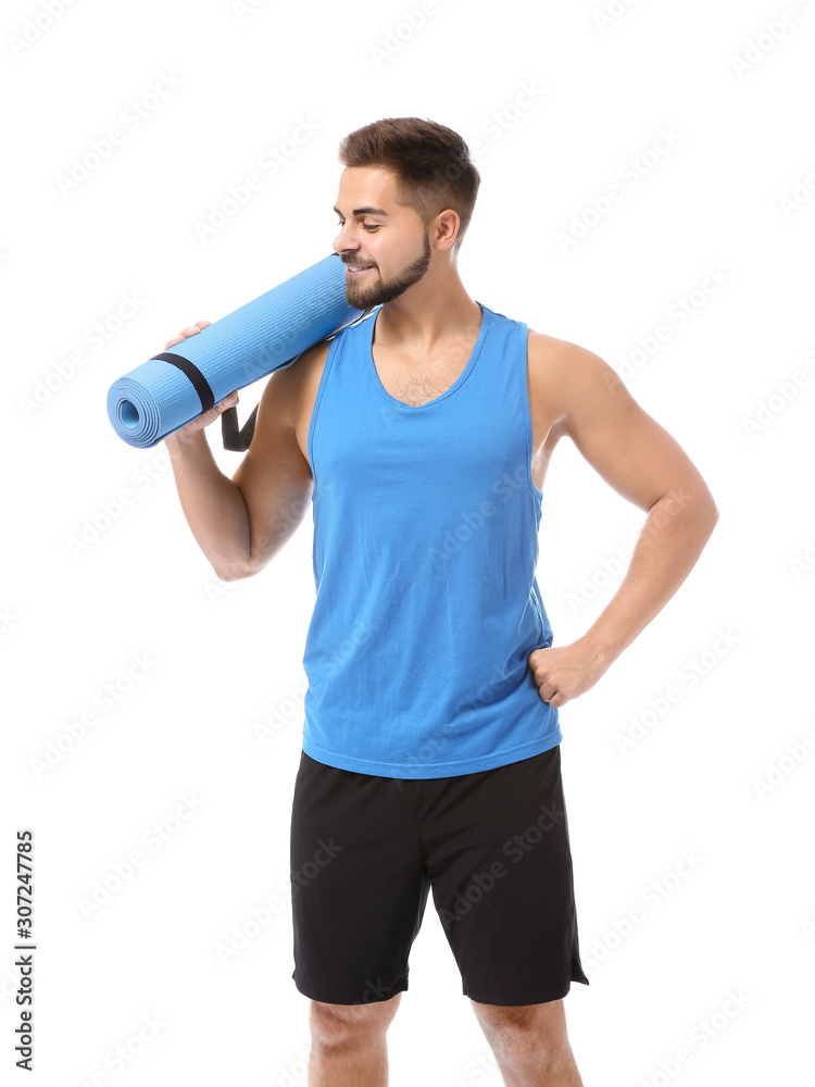 Sporty young man with yoga mat on white background