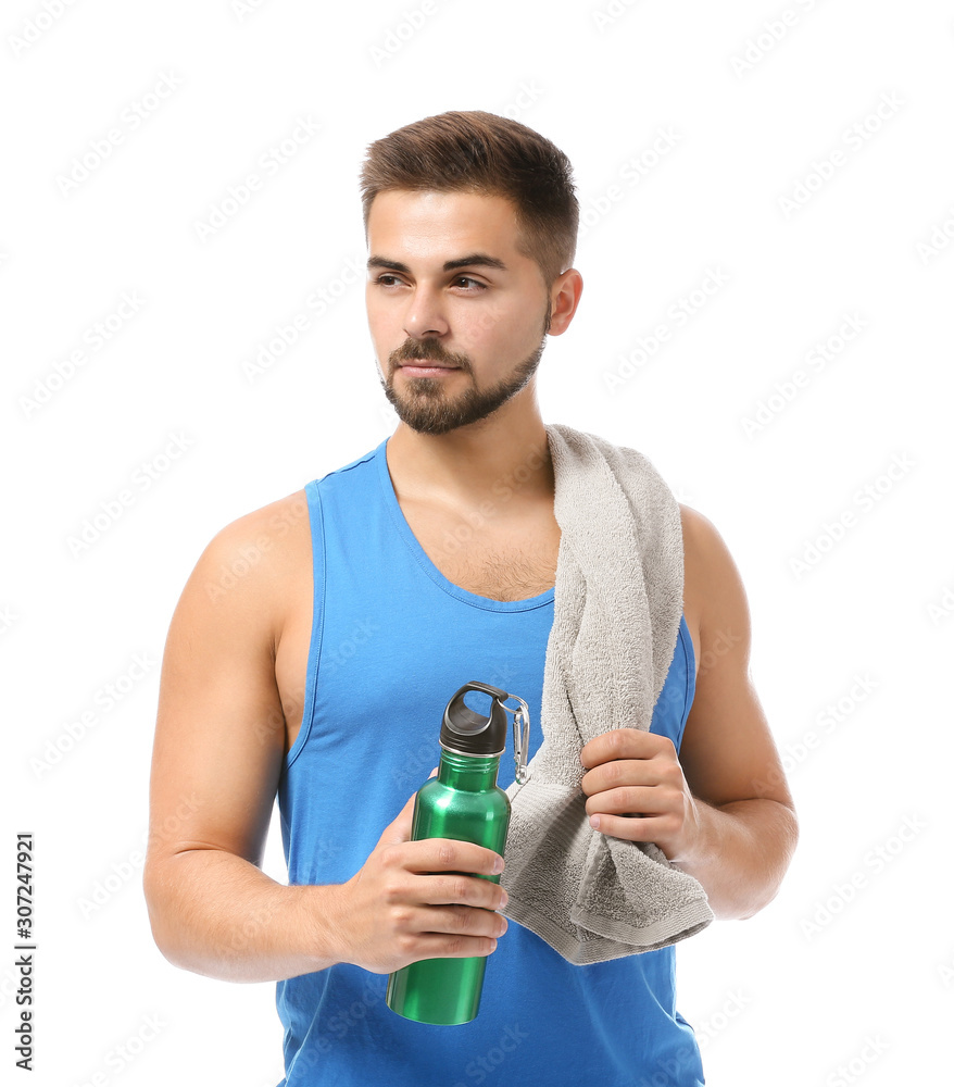 Sporty young man with towel and bottle of water on white background