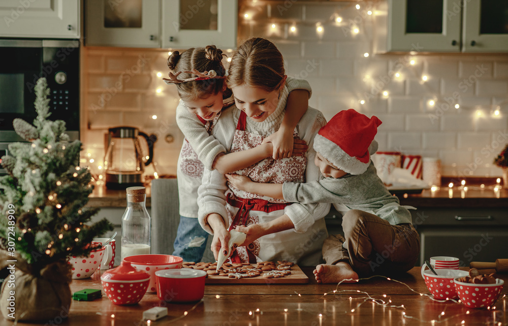 happy family mother and children bake christmas cookies.