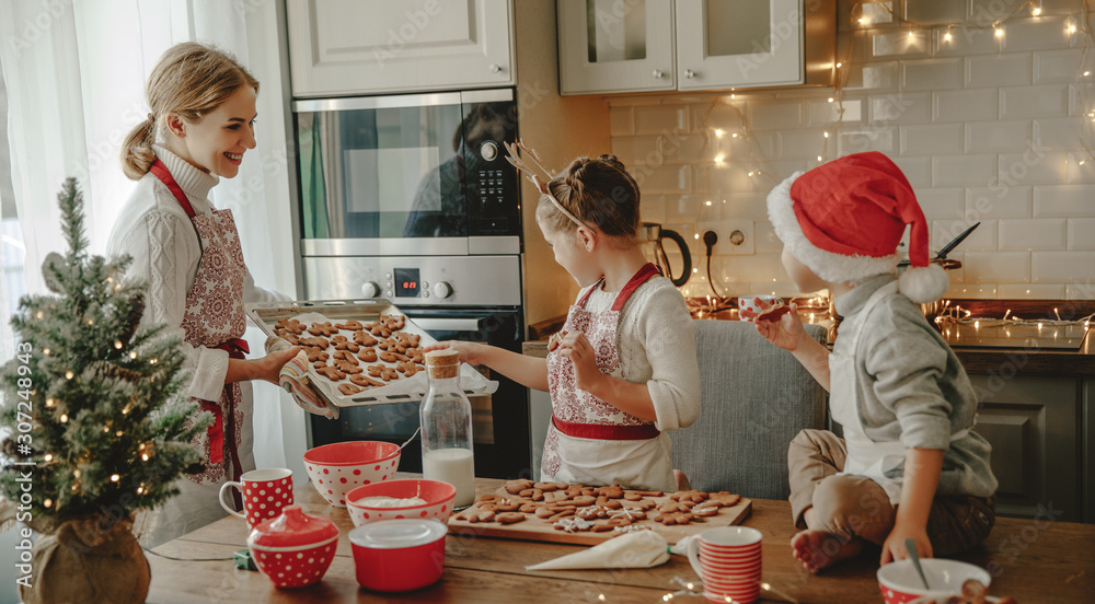 happy family mother and children bake christmas cookies.