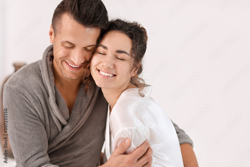 Happy young couple in bathroom at home