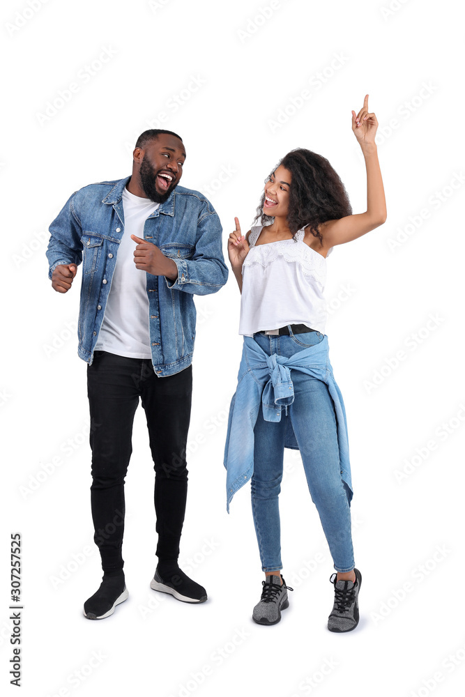 Portrait of young dancing African-American couple on white background