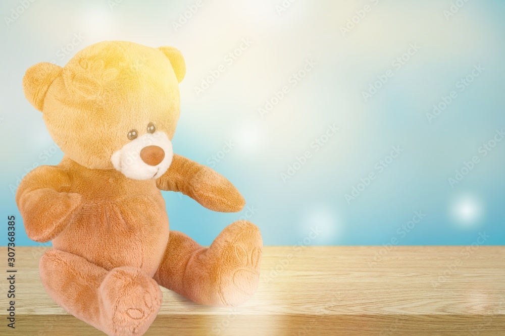 Toy bear sitting on a wooden table