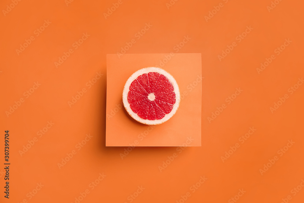 Fresh cut grapefruit on color background