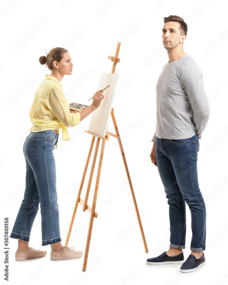 Young man posing for female artist on white background