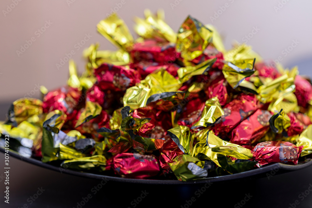 Christmas individually wrapped chocolate fondant in a bowl.