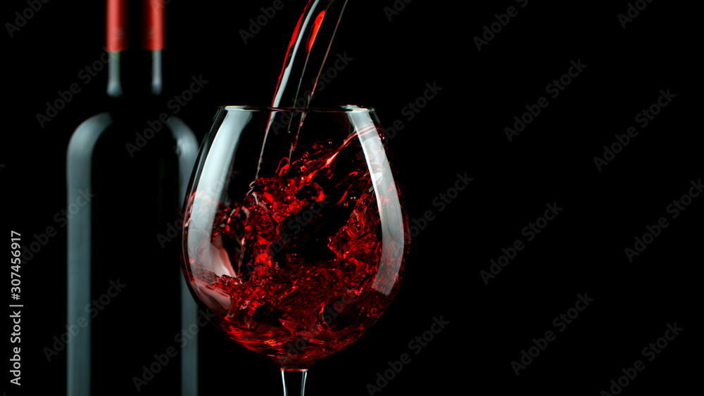 Detail of pouring red wine into glass