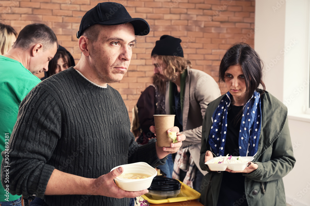 Volunteers giving food to homeless people