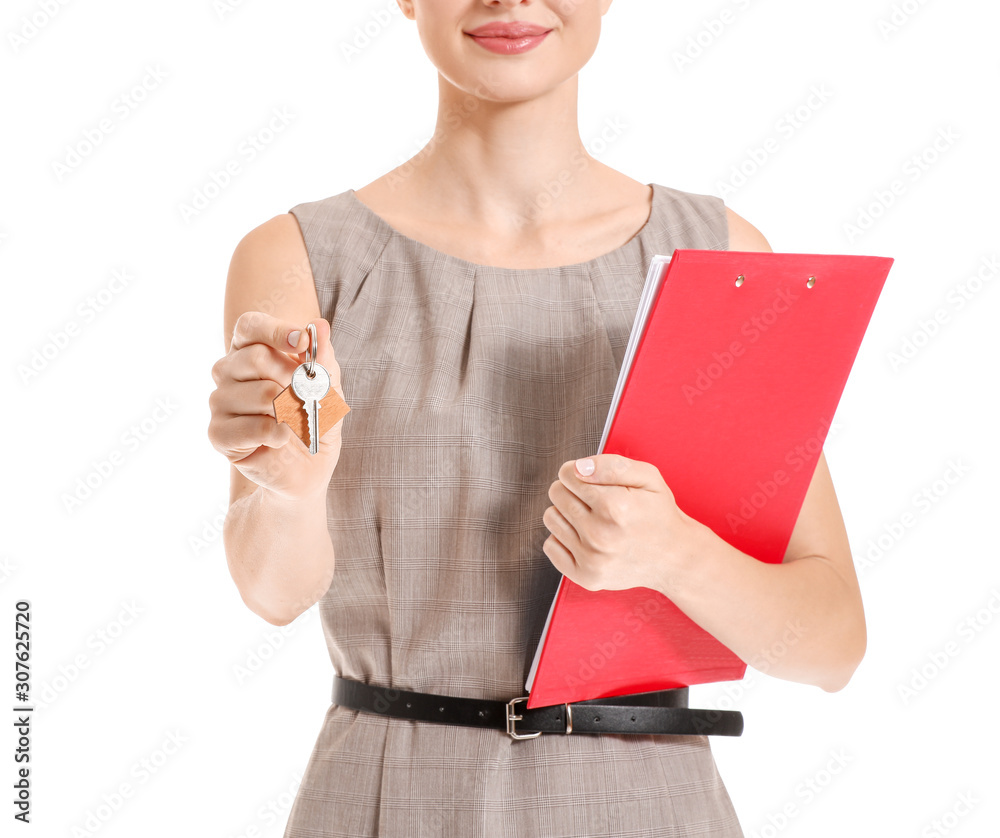 Female real estate agent with key on white background