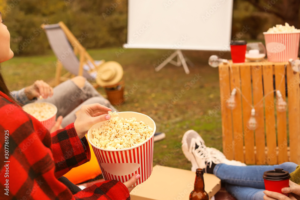 Friends watching movie in outdoor cinema