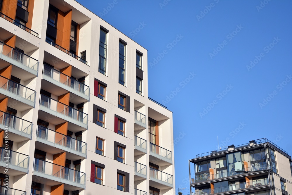 Modern apartment buildings on a sunny day with a blue sky. Facade of a modern apartment building. Gl