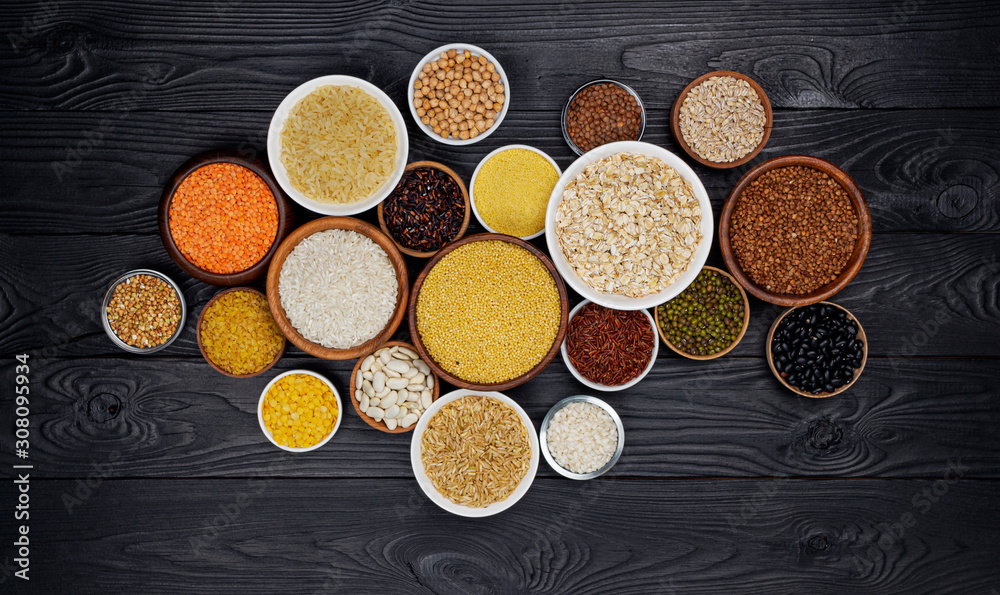 Cereals, grains, seeds and groats black wooden background