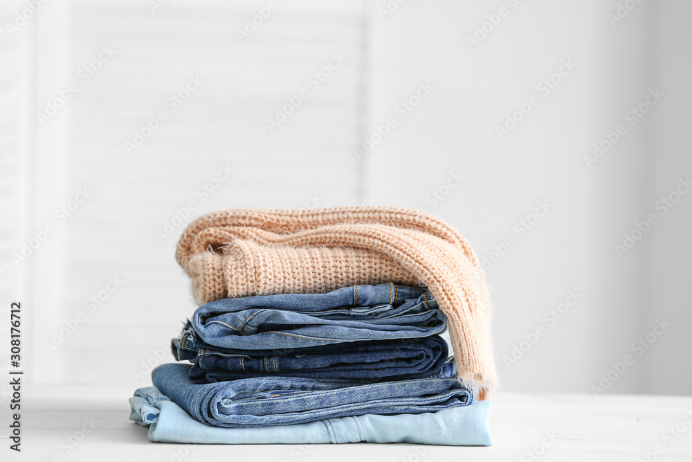 Stack of clean clothes on table in room