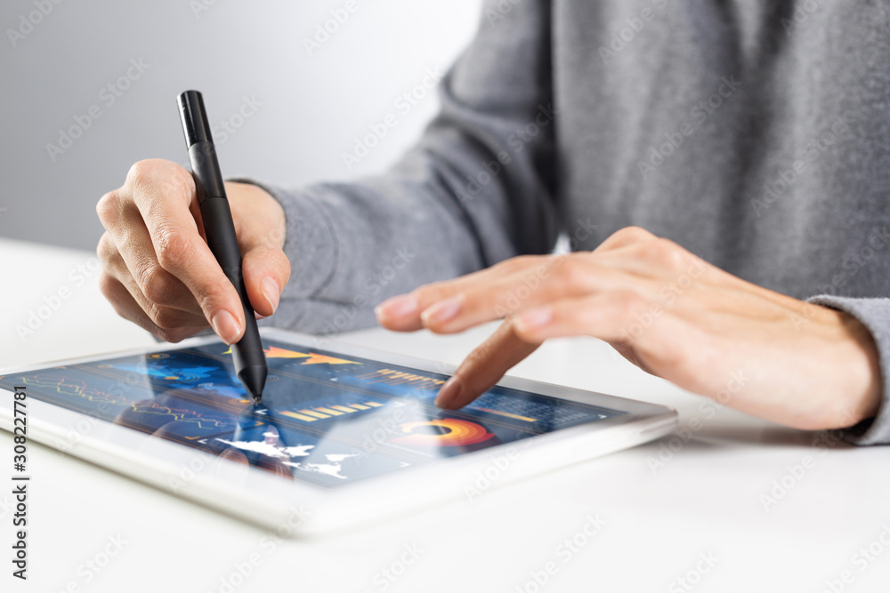 Close-up of female hands touching screen of tablet