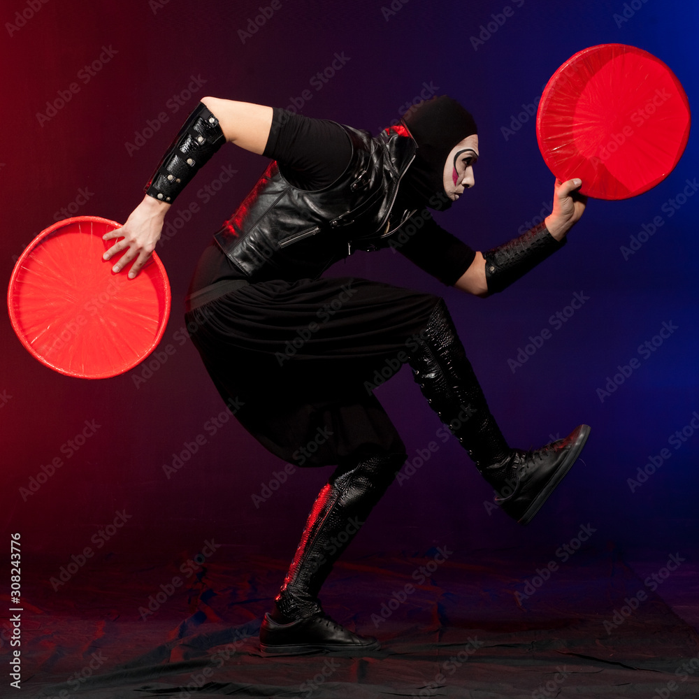 Circus juggler in costume on red and blue background