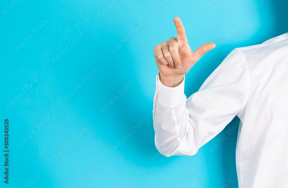 Businessman pointing his finger on a blue background