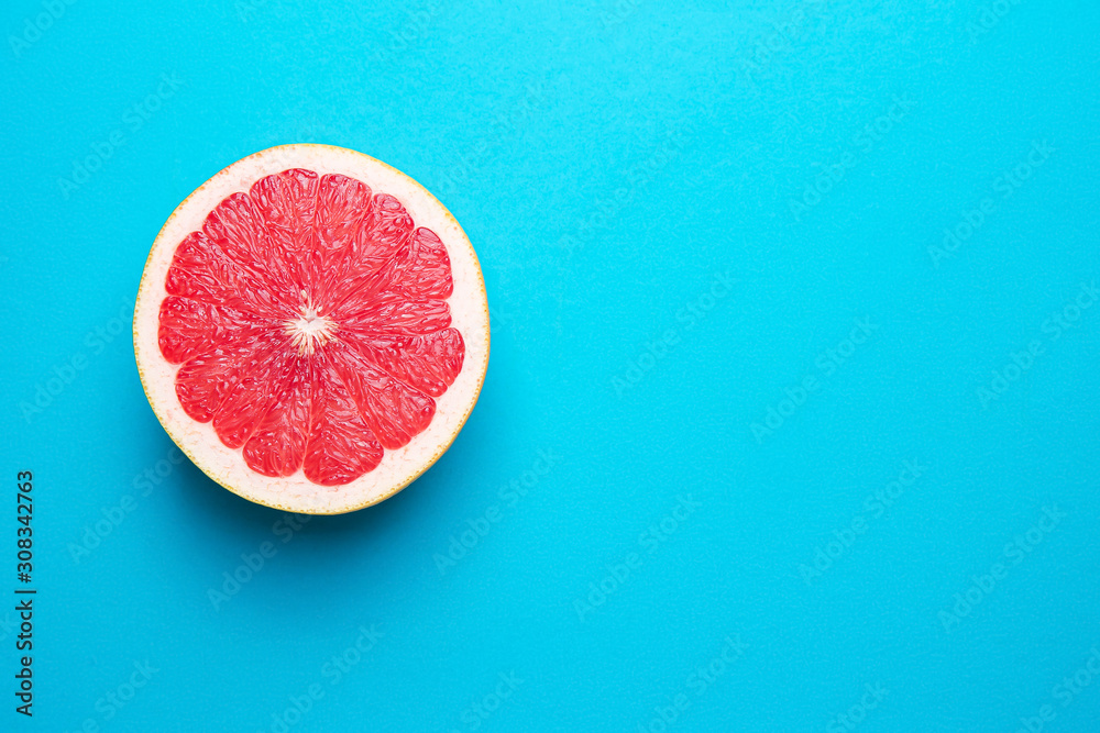 Fresh cut grapefruit on color background