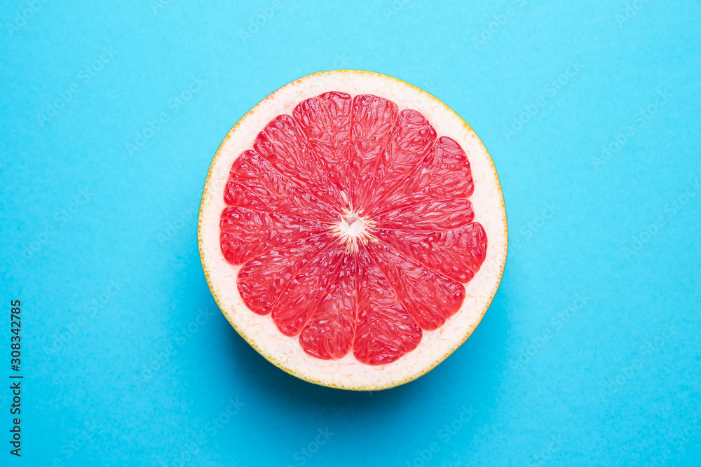 Fresh cut grapefruit on color background