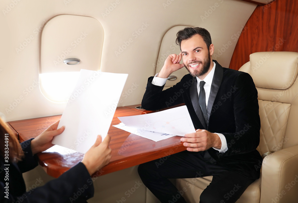 Business colleagues on board the modern private airplane