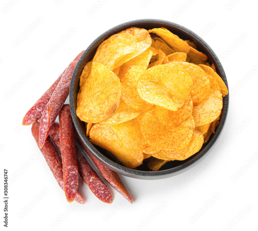 Bowl with tasty potato chips and smoked sausages on white background