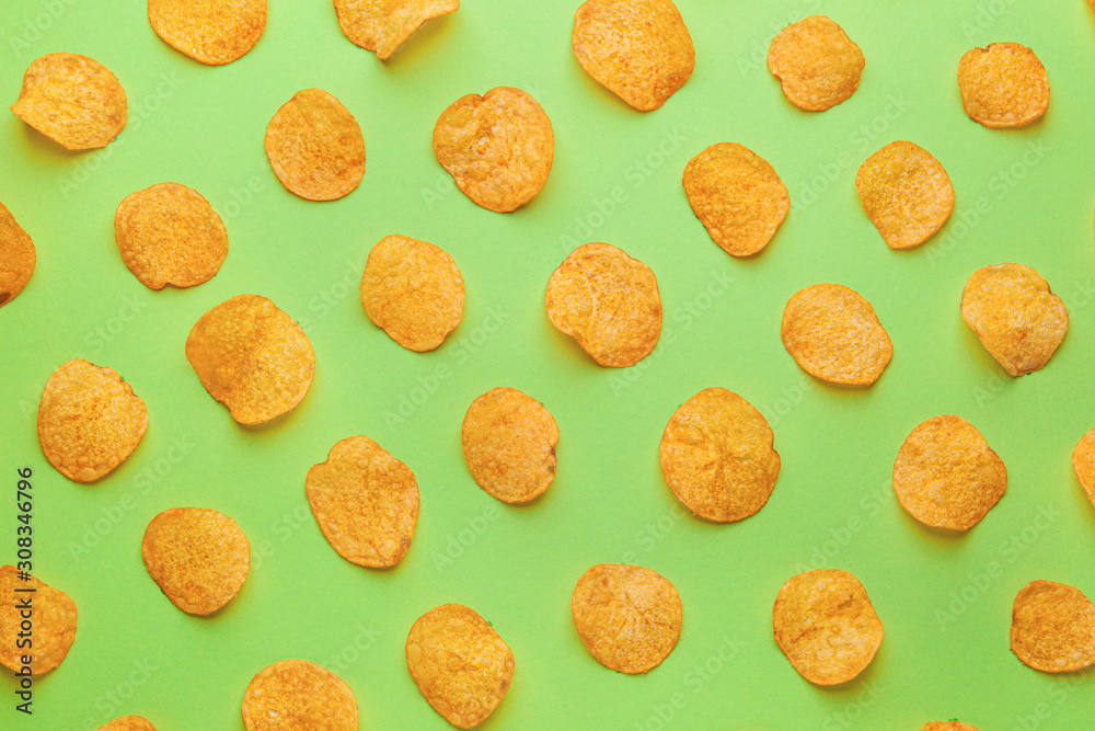 Tasty potato chips on color background