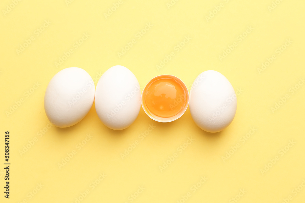 Fresh raw eggs on color background