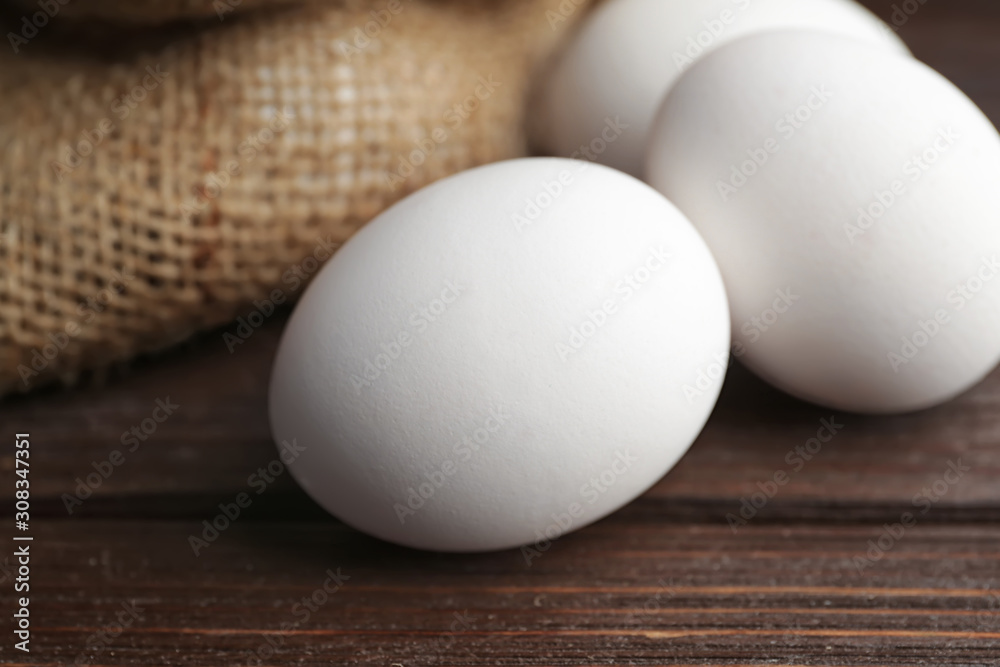 Fresh raw eggs on table, closeup