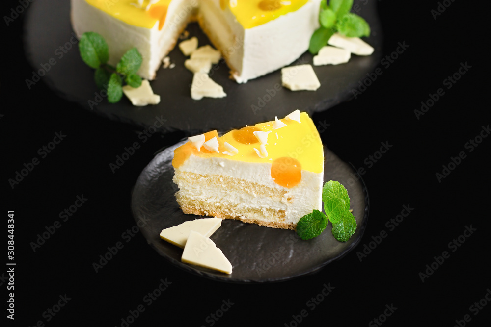 Delicious classic creamy cheesecake on rustic black plate