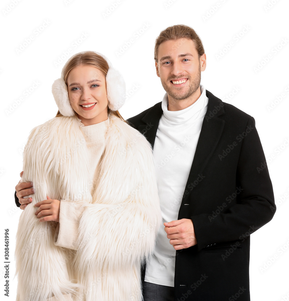 Stylish couple in winter clothes on white background