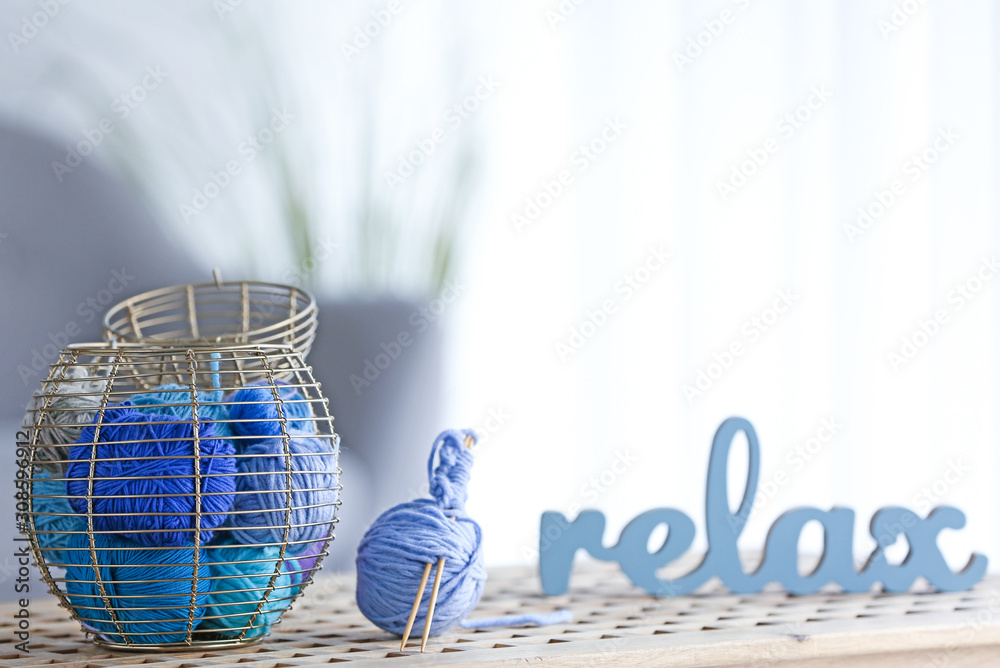 Basket with knitting yarns on table