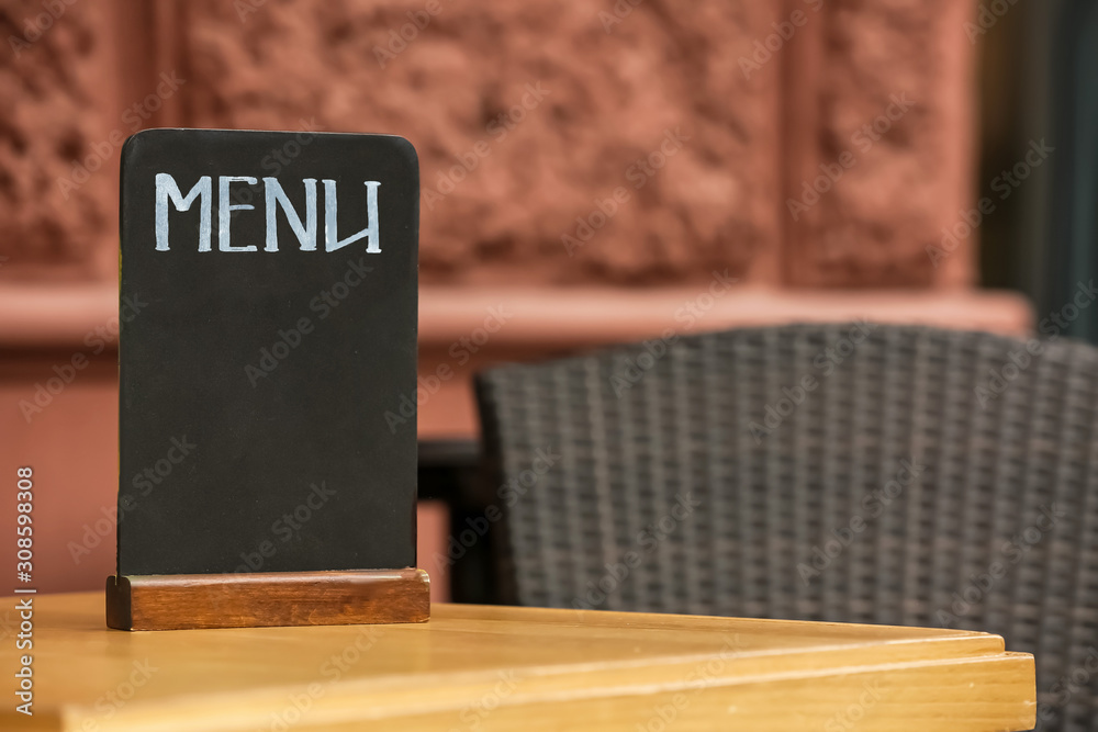 Blank menu board on table in outdoor cafe