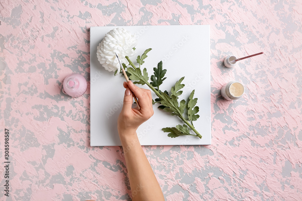 Canvas, flower and hand of artist with brush on color background