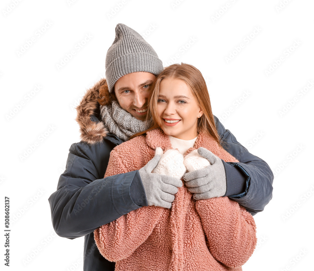 Happy couple in winter clothes on white background