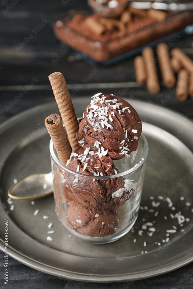 Glass with tasty chocolate ice-cream on table