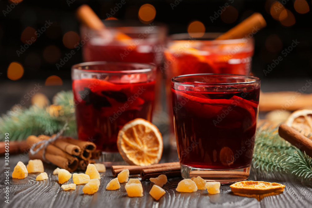 Glasses of tasty mulled wine on dark table